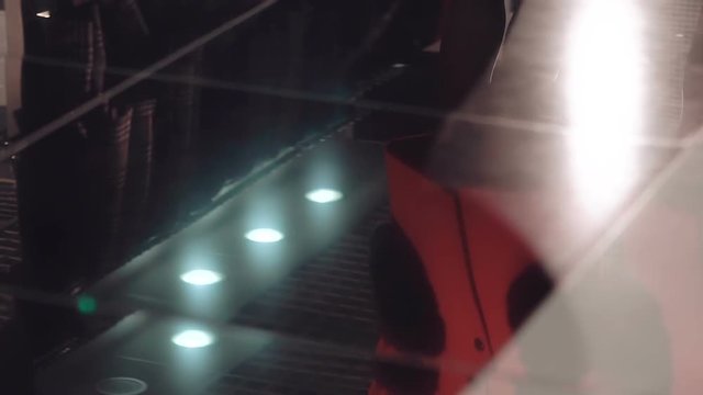 Legs of two women catwalking synchronously on the heels. Slow motion