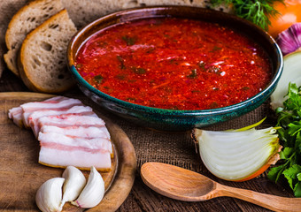 Ukrainian beetroot soup - borscht, on napkin, on wooden backgrou