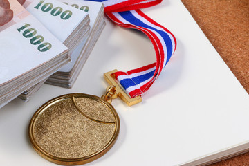 Gold medal and Thai money. Payment sporting achievements.