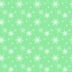 White snowflakes,christmas pattern on the green background,seamless