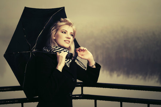 Young Fashion Woman In Black Coat With Umbrella Outdoor