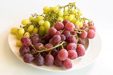 Red and Green Grapes on a white plate
