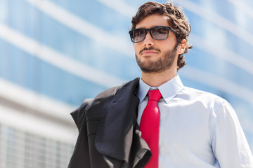 Portrait of an handsome businessman in an urban setting