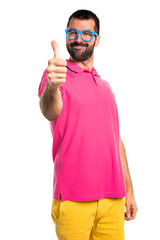 Man in colorful clothes with thumb up