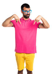 Fototapeta premium Man with colorful clothes pointing down