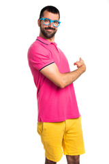 Fototapeta premium Man with colorful clothes pointing back