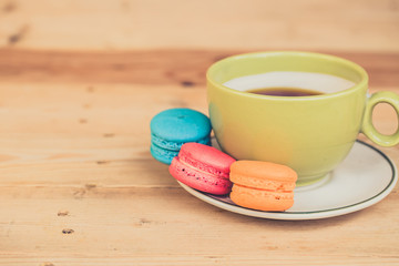 colorful dessert macarons on wood table.