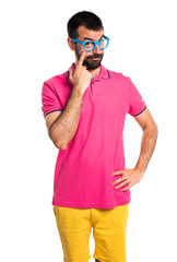 Man with colorful clothes showing something