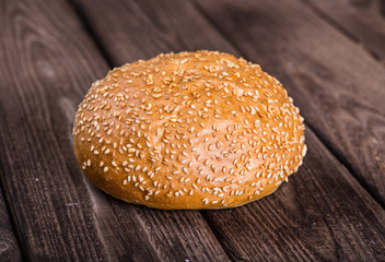 Assortment of baked bread on wooden table background