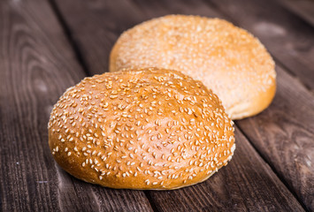 Assortment of baked bread on wooden table background
