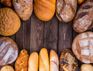 Many mixed breads and rolls shot from above.