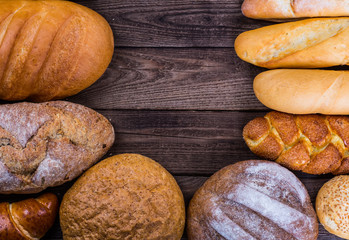 Many mixed breads and rolls shot from above.