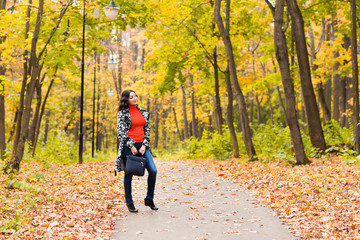 Fototapeta premium young girl walking in autumn park