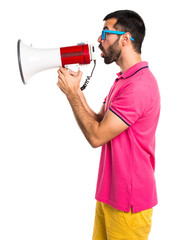 Man with colorful clothes shouting by megaphone