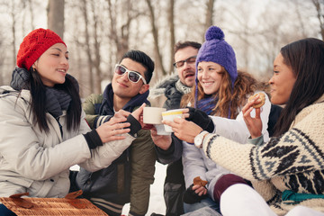 Group of friends enjoying in the snow in winter