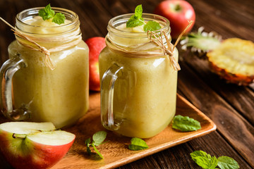 Refreshing pineapple and apple smoothie in a glass jar