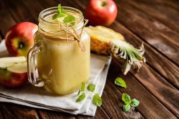 Refreshing pineapple and apple smoothie in a glass jar