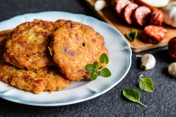 Fried sour cabbage pancakes with potato and sausage