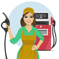 Gas station female worker holding petrol pump standing next to fuel dispenser