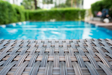 Relaxing rattan bed beside swimming pool