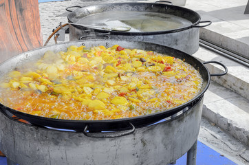 Traditionals foods of Spain. 'Potatoes of the poor' in a big cooking pot. Some ingredients of this lunch are potatoes, peppers, onions, morcilla, chorizo and other spices.
