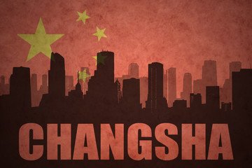abstract silhouette of the city with text Changsha at the vintage chinese flag background
