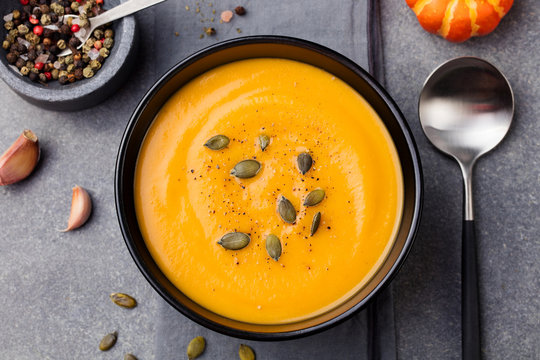 Pumpkin and carrot soup with seeds Top view