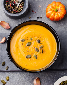 Pumpkin and carrot soup with seeds Top view