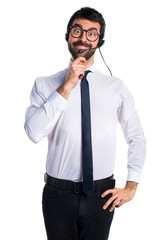 Young man with a headset thinking