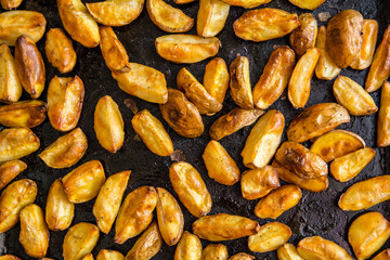 Roasted potato on a baking sheet with a spoon