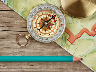 old map and compass on a wooden table