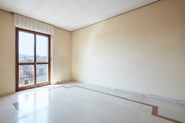Empty room interior with marble floor and dusty walls