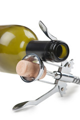 wine bottle and corkscrew isolated on white