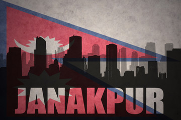 abstract silhouette of the city with text Janakpur at the vintage nepal flag background