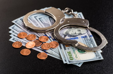 Handcuffs and money on the table
