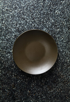 empty dark plate on a marble table. food background