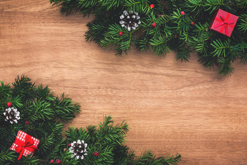 Fototapeta na wymiar Christmas tree twigs and presents on wooden floor. Christmas background.