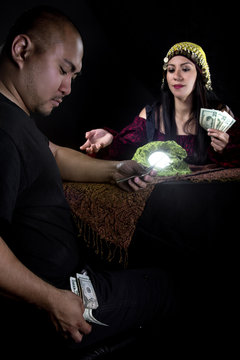 Female Fortune Teller Psychic Or Con Artist Swindling Money From A Gullible Male Customer Via Fraud