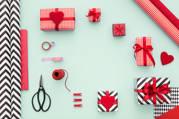 Composition of gift boxes, vintage scissors, striped and colorful papers, ribbon and tapes. Present's wrapping ideas. Flat lay.