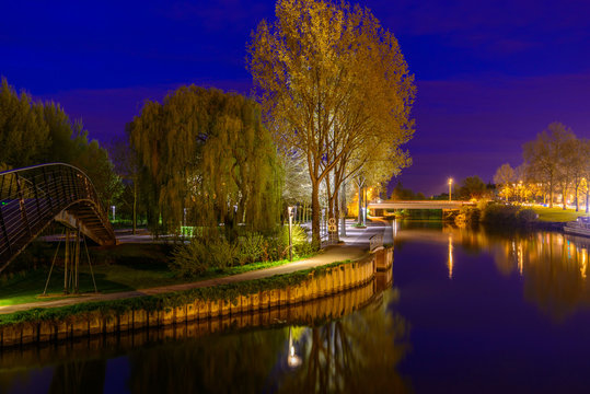 A Night in the Park. Late Spring Night in the Park. River and Park Alley. Horizontal Photography. Central Europe. France. Paris. Amiens.