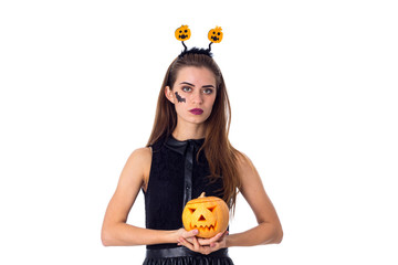 Woman with handband holding a pumpkin 