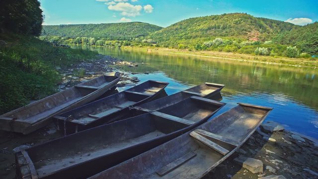 Row of wooden punts on a lake shore