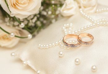 Wedding rings on satin pillow