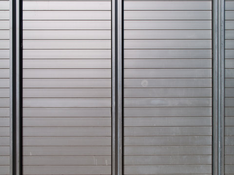 Wall made of metal plates, a little dirty and weathered, useful as background