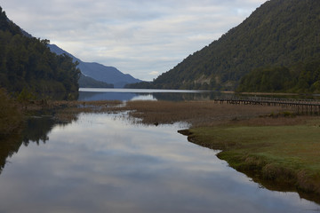 Fototapeta na wymiar Wooden pier jutting out into a scenic lake (Lago Risopatron) located along the Carretera Austral in the Aysen Region of southern Chile. 