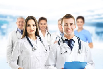 Fototapeta premium Young doctors and medical team on blurred hospital background. Health care concept.