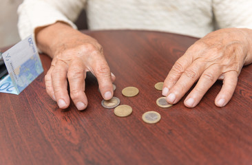 old women hands considers coins