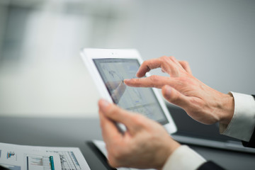 Businessman with finger touching screen of a digital tablet