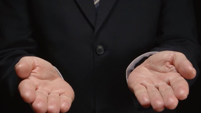 Businessman shows by hands several gestures: balance, choice, decision, solution  