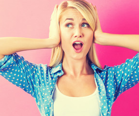 Young woman blocking her ears